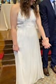 If you're looking for a simple white dress with a lace top, this dress is beautiful!! The straps are adjustable and crisscross on the back. I love the way the dress falls when touching the ground, and it is very comfortable! I will say it was very long but when wearing heels, it was the perfect length. - Paige S.