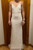 As soon as I saw this dress, I knew I had to have it but my size [wasn't] in stock so I stalked the website and ordered the second it came in stock! It fits me perfectly except for a little large in the bust, but that's expected because I'm quite small. It is quite long so will have to be hemmed but that's also expected. The beading is fantastic (it did come slightly damaged and missing some beading, but customer care was a dream to work with). The fabric is on the thinner side but for a summer wedding next year, it will be perfect. - Ashley D.