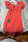 The dress is nice but it runs a little bit small and the color is more of a darker rust than in the picture. - Jazmine M.