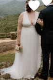 After the tailor lost my original dress two weeks before our elopement, I took a risk buying this dress without any reviews. It was better than my original! Didn't need any alterations, nor did I have the time (or trust) to do so. Plenty of stretch to fit while being comfortable + the fabric traveled great in our carry on. No way to wear a bra as it's pretty low in the front and back. I used boob tape + double-sided tape to keep things more controlled (36DDD)... but our mountain elopement was only us, our officiant, and our photographer, so my husband definitely wasn't complaining about the view. But not something I could have comfortably worn had we chosen the traditional wedding route with a reception and my grandmother and in-laws present. - Carolynn F.