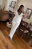 I wore this to my civil ceremony at the courthouse and loved it! Just note that the lace is low in the back so you have to opt for boob tape or braless instead of a bra. It is quite long so you'll need to alter it if you aren't wearing heels. It was super comfy until you had to go to the bathroom lol, the small button at the top was hard to put back on! Overall a great jumpsuit for wedding things! - Maya S.