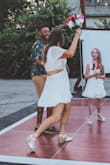 I wore this dress for our outdoor wedding reception this summer (we eloped back in March and threw a huge BBQ reception for family and friends in July). It was PERFECT. I got so many compliments on it and felt so cute and confident all night long! 

The side cutouts and semi-open back cut are surprisingly flattering! The vibe of our party was very casual, so this dress felt so flirty and fun. My best friend recommended a spray tan, so I got one about 4 days before. It looked so good!

I purchased some double-sided fashion tape on Amazon and had my sister-in-law tape the dress to my lower back (where the "skirt" part is). This kept it from folding over itself or moving around too much. 

I bought a pair of nice Spanx that were cut like boy shorts. Be careful though, and make sure you don't get any shapewear that comes up above your belly button. Because it'll show in the back. - Kathleen M.