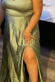 I purchased this dress for my bridesmaids to wear. The fabric/material is actually really good quality. It has a leg slit on the left side and has adjustable straps. The back has a stretchy material so it can accommodate the breasts. It did arrive a little bit wrinkly towards the bottom but I just need to steam press the dress. I am giving it 4 stars because the zipper could be improved. It's so hard to zip up past the inseam. You literally have to use so much force just to zip up/down. Other than that, the color is perfect and the fabric is good quality. - Stephanie S.
