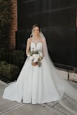 This dress was a dream! I had a disaster with my original wedding dress that I purchased from a bridal boutique and was scrambling to find a new one just two weeks before my wedding. I ordered this dress, and it arrived in four days and was perfect! In fact, I ended up falling in love with it more than my original dress! I received so many compliments at my wedding and people had no idea it was not a designer gown. I can't say enough good things about this dress, it was a lifesaver! - Leann T.