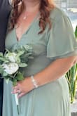 The material is typical for a bridesmaid dress. It arrived wrinkled so I had it dry cleaned. The back of this dress is so sexy! My husband loves it. I did have my aunt put a small stitch to bring in the cleavage a little because it was a little too revealing for me, but I plan to keep this dress to wear for date nights and such! - Katie R.