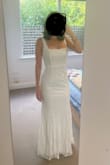 Ordered this dress along with a few others to find a wedding dress for next year. The lace overlay is really nice and the dress is nice and lightweight. I'll be getting it taken in a bit around the waist and shoulder straps but glad I went with a small, as it fits perfectly around my hips. The buttons in back need to be secured a bit so they don't all point different directions but that's an easy fix. Love the little train! - Shelby J.