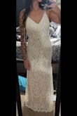 Absolutely beautiful gown. Thin, lightweight. Pretty obvious seams, but that's to be expected with the cost. Not the one I ended up wearing for my wedding, but kept it for a future event or vow renewal. I think a deeper V would have really helped in the bust area, and the zipper seems very cheaply made. - Amanda L.