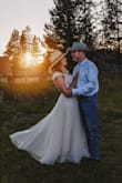 I loved this dress from day one. I ordered it and sat on it for a year while I tried 50 other dresses, but kept coming back to this one. My family didn't like it in the beginning so I kept trying to talk myself out of it. Well, I'm glad I didn't! It was PERFECT for our July country wedding. My hubby thought it was super sexy despite me being classy, as well. It's also super comfortable and breathable. I had cap sleeves put on as the sleeves had a bit too much poof for me. Also, I had the nude skirt lining lengthened a bit and pinned down so it wouldn't ride up. Worked with cowboy boots for the win! I even did a skirt change halfway through the night! Paired it with a champagne tulle skirt and a cowboy hat. - Heather K.