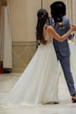 I wore this as my white dress for my wedding! I was in between a 2 and a 4. I had to order the 4 and have it taken in slightly and hemmed the front. The dress was very comfortable, light, and flowy. I was only in it for a few hours before I changed into my other dresses. - Lisa L.