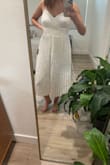 This dress looks super cute on the model but the top does not lay well if you have a larger chest. The pleating in the dress also looks really odd and is bunched in the middle. The bottom is too big but I don't think a smaller size would fit my chest. As a final sale item, you can only exchange for a different size so keep that in mind when buying. - Kaitlin M.