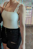 The bodysuit is cute but is definitely a little see-through. I wore a nude bra but you could still see the outline. Otherwise, it's cute and comfortable! - Lorelei H.