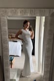 This dress is really flattering and SOOOOO comfortable. Unfortunately, it didn't make me feel bridal enough, but if I hadn't wanted it for my wedding, it would've been a perfect dress for any other event. I material was stretchy and made me feel so relaxed yet classy. - Lenae L.