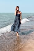 I love this dress. I wish it was structured slightly differently or had less or a different fabric weighing it down. Or perhaps if I had a bigger bust to hold it up being strapless. Just to keep in mind. I only recommend sizing down for the structure of it, and its stretch back panel allows for you to easily. - Shana W.