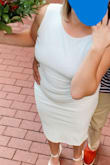 I got an XL and this fit true to size - it definitely shows all the rolls etc but because it's open back, it does give a little 'wiggle' room if you're worried about it being tight. I loved the length as I'm a bit shorter. It was very comfortable and I just the right amount of formal for our courthouse wedding. - Lindsey T.