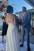 I wore this dress for my wedding when I was 6 months pregnant and it was great! The top is very flattering and I loved the back. I added a sparkly belt to give it a little flare since it's on the plain side. I did have to get it hemmed as it was quite long (there's a beautiful train as well) and I also had the sides let out. It was quite snug on the day of the wedding, so I probably could have done a large but had ordered several weeks prior to the wedding and the medium worked. My pre-pregnancy size is a small. The only complaint I have is that it didn't have a hanging ribbon on one side, so I just had my alterations lady add one. - Becky D.