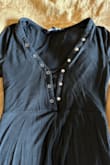 I'm short at 5'2 and the height of this romper is perfect. Anything shorter, even a fraction of an inch, would definitely cause camel toe issues. This works well for me but should be considered petite imo! 

I am flat chested and rely on all the buttons with this type of neck line to avoid draping if I bend over. I purchased because I thought I'd be able to snap additional buttons to cover more of my chest. What I didn't expect was for the snap buttons to not be in a straight line (see picture). All buttons are still useable but it looks weird / bunchy when you button more than what I guess it was designed to. 

Lastly, this item smelled heavily of burnt rubber. Probably from the manufacturing process. I aired this out in the sun for a week outside. No change. I washed and again let air out in sun for another week and it still faintly smells like burned rubber. 

I do not recommend this product. Such a shame because it's cute, lightweight, and fits me perfectly (other than the neck line issue) - Kimberly T.