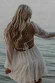 I got this dress for my engagement photoshoot and oh my gosh it is stunning! The best dress I've ever owned. The sleeves do fall down a little but that is expected when the back is so open. Highly recommend! - Jessica H.
