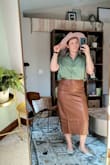 I usually wait to buy things on sale, but I had to have this skirt. So chic, can dress it for fall or spring. It is surprisingly weighty and not flimsy! I was nervous it not fitting my wide hips being that it's a pleather material, but slipped on no issues. Maybe a touch snug around the waist, but not uncomfortable.
I bought a medium. Took pics right out of the box, have not tried getting the creases out yet. - Abigail M.