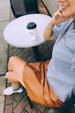 Really love this vegan leather skirt that fits as a high waist and pleats naturally. The color is dark camel and zips in the back. Very city slick and conscientious. Top! - Simone B.