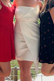 I am obsessed with the angles of this dress. It makes me feel so fashionable. Downside is the front tends to slip pretty low. The dress has something at the top that's supposed to help it stay up, but the top is too loose for it to actually work. Aside from that, I love it and feel amazing it in. I've worn it at my bachelorette and will wear again for the rehearsal. - Katie G.