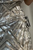 The sequins don't lay flat on the seams at the side, and at the right angle, you can see gaps in the stitching because of it. It just bunches up everywhere it shouldn't, looking awful and cheap. The zipper seems to stick a bit as well. - Shannon K.