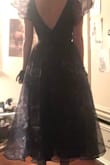 This dress is so much fun!! It's unique and flirty and makes you feel like a fairy princess, I got so many compliments on it! Plus it's so comfortable and fits just right. Sorry for the poor quality photo. If you get this dry cleaned before wearing, they will smooth out the top layer of fabric for you and it will feel almost silky. If you don't like how far out the puffed sleeves go, you can pin them a bit underneath your arms. Note that it's longer on me because I'm only 5'1. - Jenna C.