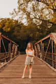 Bought randomly when scrolling through clearance, and so glad I did!! Worked great for senior photos. It was a good length, being short but not super short. The waist was very tight when i buttoned it on the inside, but it did not snap or anything and I just had to suck in a little bit for photos haha! I don't think I would have sized up anyway because it would be too big everywhere else, so stick to your normal size. For the price too, definitely buy!! - Rachel C.
