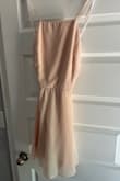 It's cute and it was a great deal. I like the top part and that it's backless. However, it's kind of short. And there aren't any pockets, which is a bummer. Fabric easily wrinkles too. - Elsa A.