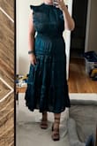 It runs a little large which isn't great since it's already a bulky dress. I feel like I am too big to pull off this look. It's pretty from the front but that's it. Color and material are stunning though. - Maggie S.