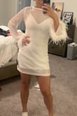 This dress is fun and good quality! I love the subtle sparkle and the fun feathery sleeves! I will be wearing this for dinner post-wedding elopement, and I could see the sleeves potentially being annoying when trying to eat. I wanted this to be very form fitting, but it is a little loose and a little too long for me being 5'2. The slip underneath does help give me more of a figure, but the dress itself is a bit boxy/doesn't accentuate my curves as much. - Tiffany B.