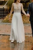 This dress is stunning! I received so many compliments and was so comfortable in this dress on my wedding day. I love the beading on the bodice and it was not see-through. The skirt needed a little hem but the bodice fits perfectly for my size 2 top (I am an A but I think a few other cup sizes could work with this bodice). There is not a lot of stretch in the bodice so if you are between sizes, consider sizing up. It was a cooler/overcast summer day and I did not get hot (but also typically run cold). I've already offered this dress to other engaged friends to borrow and I am planning on getting it hemmed to knee length for anniversary celebrations. Highly recommend!! - Patricia R.