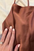This is actually a bodysuit, which I wasn't expecting, but it fits just right and is really cute on. I got quite a few compliments. The color is darker than in the photo though, which I really wanted the color advertised. - Sheena K.