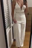 The jumpsuit is lined; it's thick, feels like good quality, and very well made. Although, the jumpsuit is long, definitely made for someone who's 5'8" to 5'10". The inseam works well for shorter ladies like myself who are 5'2". I will be getting the jumpsuit hemmed. Overall, great fit, I love it, perfect for my upcoming vow renewal. Please note the jumpsuit does not come with the belt, but the belt was purchased on Lulus as well. - Beatriz C.