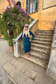 I purchased this dress for a wedding in Italy. The material almost changes colors in the light! It's a very sparkly blue with stretchy material that hugs your curves. - Marti C.