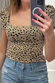 I recently got my hands on the "Oh Darling Black and Tan Dot Print Puff Sleeve Top," and it has quickly become a favorite in my wardrobe. The black and tan dot print is both classic and versatile. What truly sets this top apart are the puff sleeves, which add a touch of elegance and flair to any outfit. - Faith B.