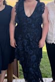 I purchased this dress for my bridal shower. I put it on and it fit perfectly! The layers disguise the middle area and the v-neck was perfect and tight enough to have a nice plunge that girls weren't going anywhere. I would've purchased the white but it was out of stock in my size! Highly recommend it! :) - Abigail J.
