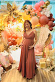 I bought this dress for my baby shower dress. I usually wear a size medium pre-pregnancy but I sized up and got a Large and it fit perfectly. I did need some help with the zipper. The bust area was a little loose and bigger on me because I'm small breasted. I wear a size B in bra so it was big in that area but otherwise, it fit beautifully! I absolutely loved this dress. It's so elegant and beautiful! - Janique R.