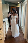This is a lovely dress and looks so much more expensive than it is. Amazing quality and detail. I got so many compliments and nobody could believe it when I said I got it from Lulus. I'm a small 34B and there was a LOT of room to spare in the chest area, so I got pads added and didn't have to bother with a bra. I didn't love the spaghetti straps, but they stayed up and I didn't have any issues. I did have to get the straps shortened, 3 bustles added, and the dress length taken in quite a bit which was very expensive due to the layers and detail on the train (alterations cost more than the the actual dress!), but the overall price of the dress and alternations was still less than I anticipated spending. Overall very pleased with this purchase! - Lauren C.