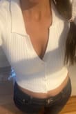It's a soft, stretchy, and sophisticated white collared top that can easily be dressed up or down. It is crop so if you don't want to show skin you'll have to wear with a tank underneath or high waisted bottom. Slight cleavage. The picture is more pronounced because I took it from above. I love everything about this top. Recommend! - Marline K.
