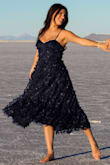 The tulle layer with the butterflies gives this dress a ton of beautiful movement. I am typically between a 4 and a 6 size-wise and went with the small. It gave my chest great support and I felt very secure without a bra. I would purchase again and again. - Demi P.