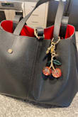 It's definitely a nice quality shoulder bag! It's not too big and very spacious. I wish it came with extra storage installed in the bag. The middle detachable bag is nice but isn't convenient because the zipper barely opens wide enough. Overall, it's very nice. I love it! - Lylah B.