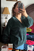 The material feels thin but still of good quality. The color is more teal than emerald green. The back is a bit longer than the front so that feels nice, it gives the sweater a cozier feeling. The cuffs are tight but in a good way, so cold wind won't come up to your arms. I loved it. I'll definitely get it in a different color. - Amparo C.