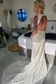 I saw this wedding dress shortly before I got engaged and knew when the time came it was the one I wanted. I purchased as soon as I was engaged and didn't look at or try on any other dresses. This fits absolutely perfectly, in all the right places. We had a beach wedding in Jamaica and it was lightweight so it wasn't too hot and the lace held up extremely well in the sand. I couldn't have asked for a better dress for the greatest day of my life! I couldn't be happier with it! - Alyssa R.