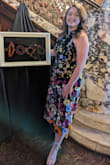 I wore this dress to an art gala/business event. It was the perfect unique dress for that artsy look while keeping it professionally modest at the same time!! Compliments all night. The halter is minimalistic and has great boob coverage for those who tend to have curvier boobs on the edges. The slit is not drastic. Some flowers are built into the dress fabric, and some are "extensions" of the dress more 3D. Really adds to the style, but just something to be mindful of. - Diana M.