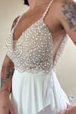 I bought this dress for our destination wedding in Barbados. It is super pretty and of amazing quality. The beading is very nicely done and the fabric is nice. I ordered a medium, but the top was too big, so I sized down to a small and it fits perfectly. The dress is very long, even with heels. I plan to have the front of the dress hemmed. I have included pictures of me in the small, I don't have a full-length photo yet. I got a great deal with a promo code, free shipping, and a super easy exchange process. - Nicole W.