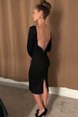 This dress is slim fit but not pasted on. It is a thicker material with boning in the back to hold its shape and keep you feeling smooth all around. I wore it as a guest to a formal wedding and it was the perfect level of dressiness. If you have wider hips, yes, it will rise up a little when you walk but not much and it's easy to pull it back down. - Alicia E.