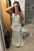 I'm having a micro wedding and have been following this dress for some time. I saw it was on sale and bought it (I spent a little over $50... even if it didn't work, can't beat that). I am a size 4-6, usually small/medium top and medium bottoms. I went with a medium at first, and there was definitely a little extra material but it was pretty fitted on my hips/bottom. I was hesitant to return for a small, as I figured I'd just get it altered. I went for the small, and it fits like a GLOVE. So happy I exchanged it. I feel like if you're between sizes- go with the smaller of the two!! - Christina S.