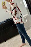 Got a lot of compliments on this shirt! It fits like any loose blouse in this style. I got an XS; I can usually swing between S and XS but go for XS on loose tops like this. I have long arms, and the sleeves were definitely long enough! I half-tucked it into the front of my jeans for work. - Megan S.