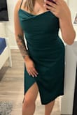 Bought this dress for an engagement dinner with family. This dress fits great in all the right places! There's no stretch to the fabric at all though, so it feels a little tight, but I wouldn't change my size. When you sit down, the leg slit rides up quite high, but when standing, it's perfect! I'm a little self conscious about my tummy area and hips, but this dress hides everything well. If you want a little bit of a looser fit and movement in the dress, then size up for sure! Highly recommended though! - Nataya D.