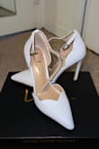 These shoes are beautiful, and the scalloped edges are amazing and make these shoes unique to others. There is almost no traction on these shoes, so I will need to buy something to put on the bottom so I don't wipe out walking down the aisle! They are just a bit narrow on my feet, but if I size up, I think they would be too big so I'll stretch them a bit. If you have thicker ankles or issues with retaining water in your ankles, these may not be the shoes for you. I don't have big ankles, but I am almost to the last hole when closing the ankle strap. - Jenna S.